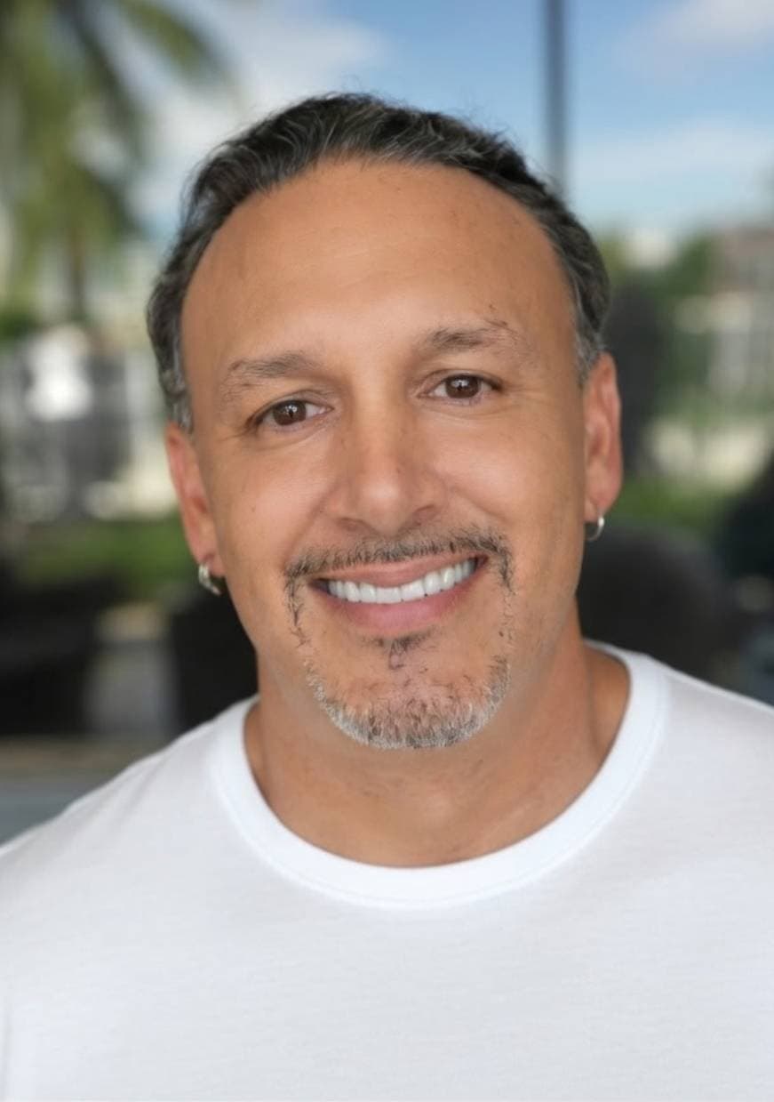 Rocco Generoso Jr (Rock / @Rockmetax) smiling in a white t-shirt